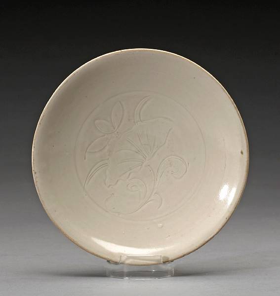 Appraisal: A Dingyao dish with carved lotus decoration Northern Song Jin