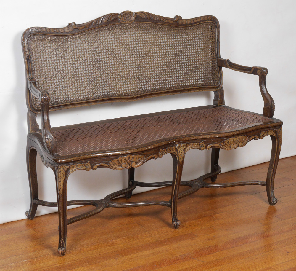 Appraisal: PROVINCIAL LOUIS XV STYLE SETTEE Early th century the caned