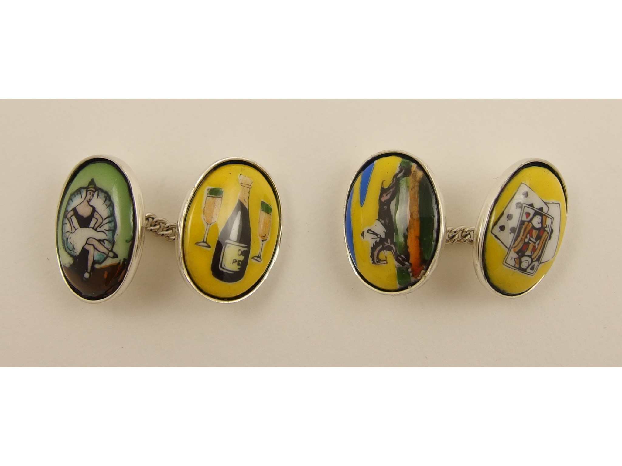 Appraisal: A pair of silver cufflinks depicting the four vices of