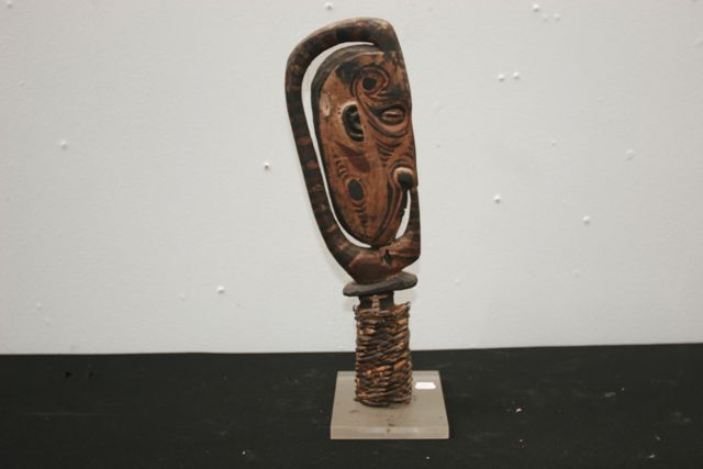 Appraisal: A sacred flute stopper carved as a mask embellished with