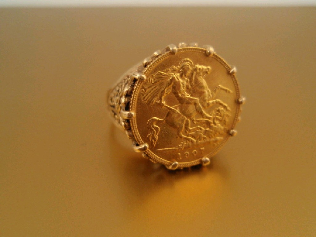 Appraisal: A half sovereign set dress ring set in an ornate