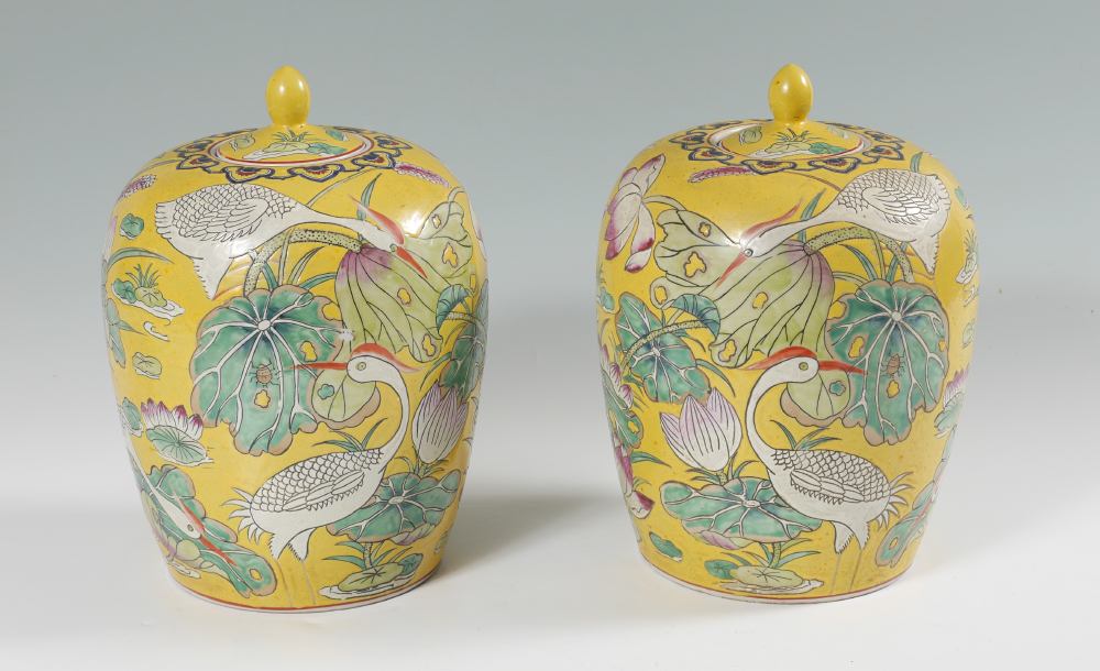 Appraisal: PAIR FAMILLE JAUNE CRANE MOTIF COVERED JARS Mirror image pair