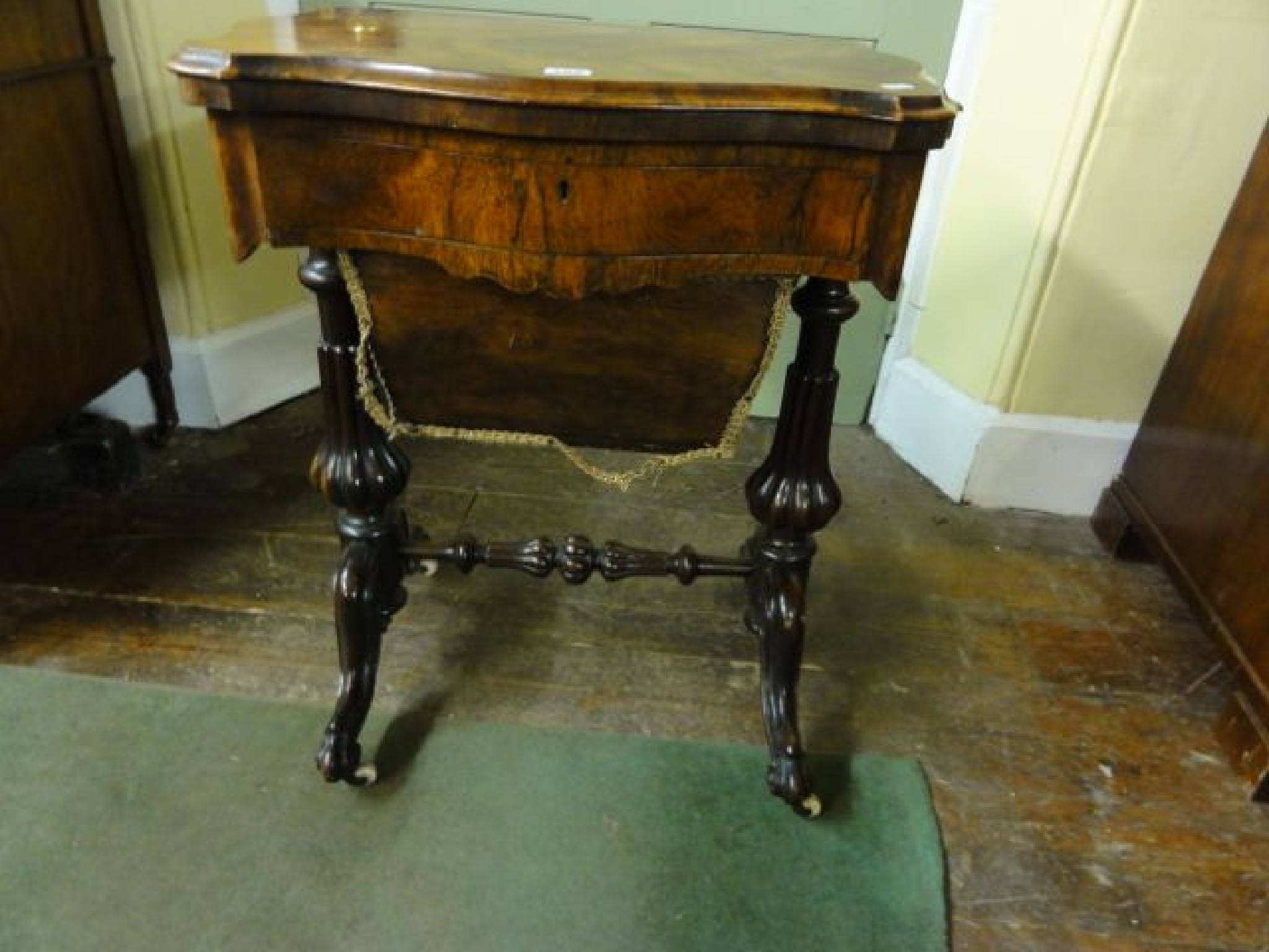 Appraisal: A Victorian rosewood ladies occasional table the fold over top