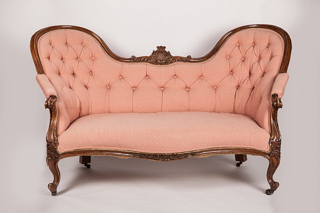 Appraisal: A VICTORIAN DOUBLE SPOON BACK SOFA with carved serpentine shaped