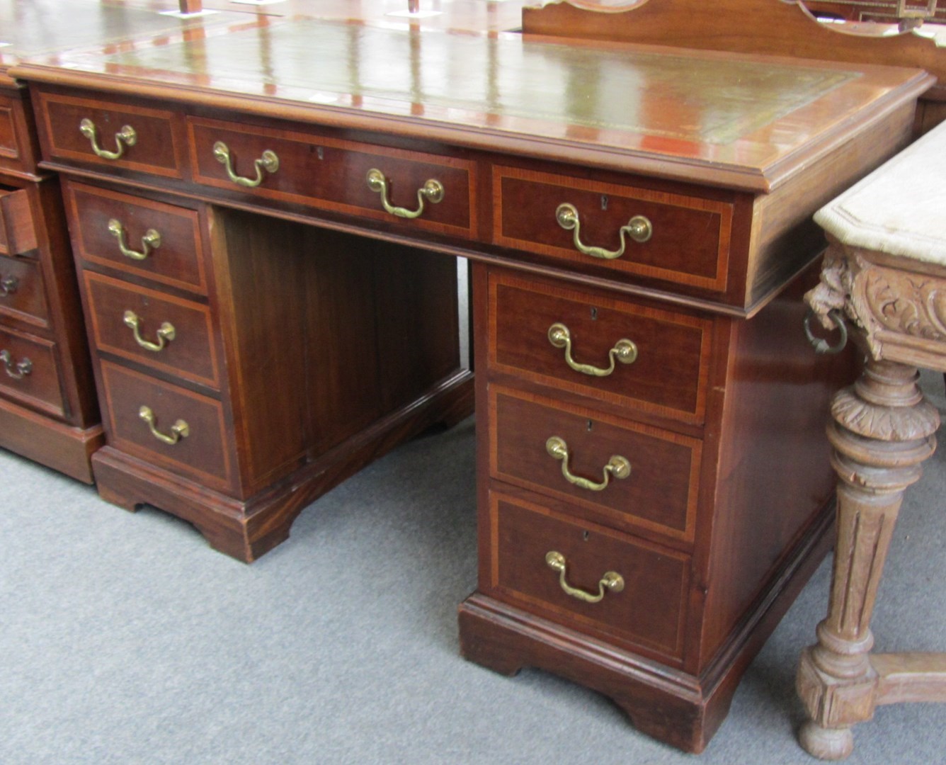 Appraisal: A late th century crossbanded mahogany pedestal desk with nine