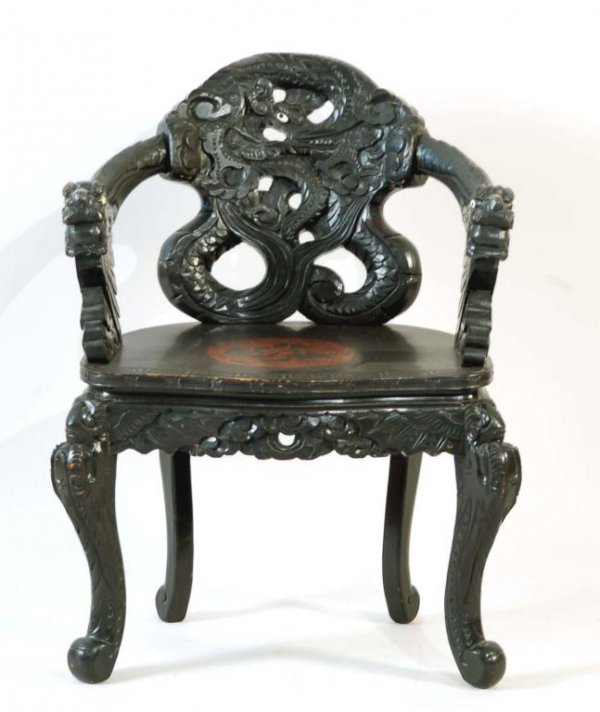 Appraisal: A highly carved and elaborate carved and lacquered arm chair