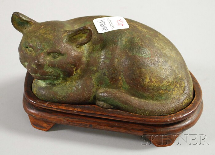 Appraisal: Asian Patinated Cast Bronze Recumbent Cat with hardwood base cat