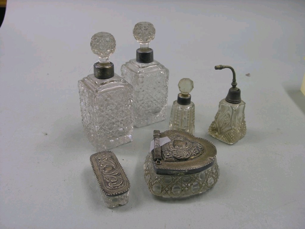 Appraisal: A silver mounted cut glass dressing bottle heart-shape another rectangular