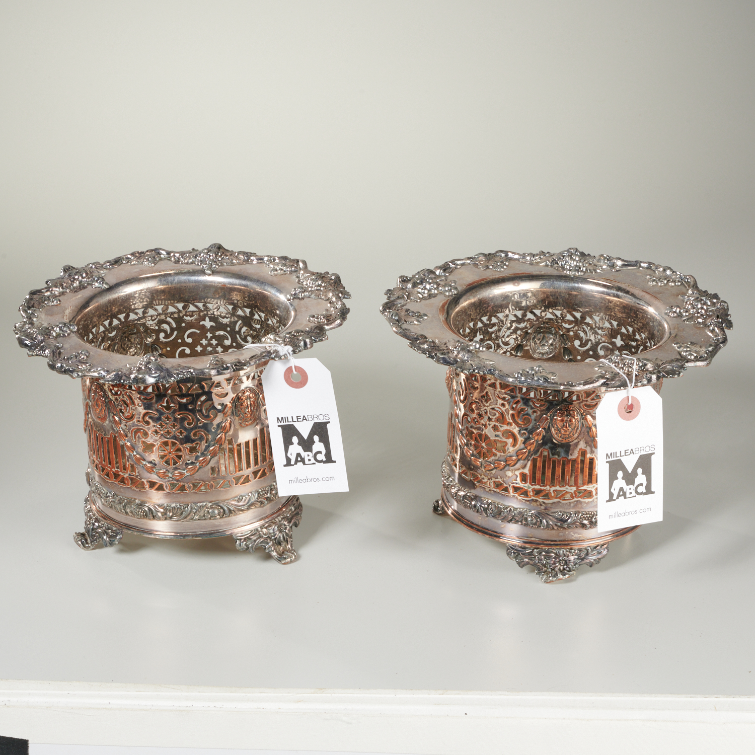 Appraisal: PAIR ENGLISH PIERCED SILVER PLATED BOTTLE CADDIES Late th c