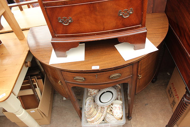 Appraisal: A SMALL EDWARDIAN MAHOGANY DEMI LUNE SIDEBOARD with central drawer