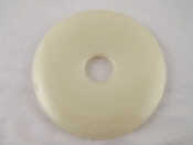 Appraisal: A Chinese green hardstone bi disc cm dia