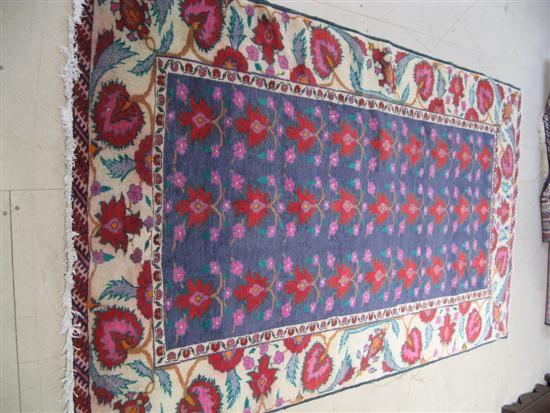 Appraisal: Persian blue ground floral decorated carpet with one main pale