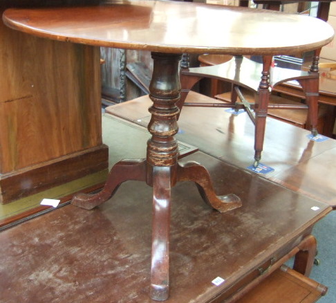 Appraisal: A George III mahogany occasional table the circular snap top