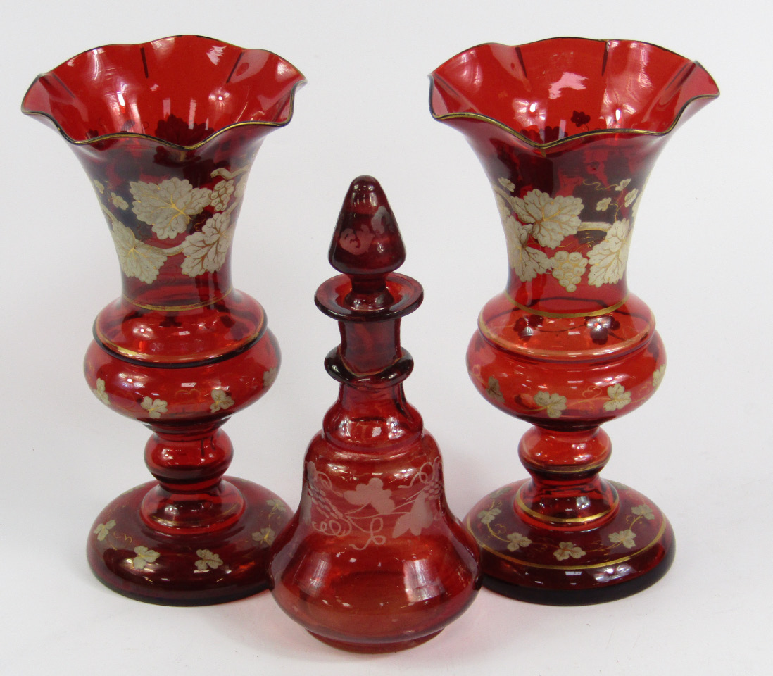 Appraisal: A pair of Bohemian ruby glass vases over decorated in