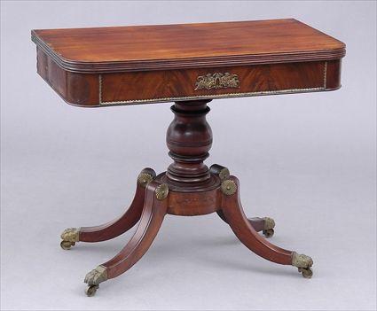 Appraisal: REGENCY BRASS-MOUNTED MAHOGANY GAMES TABLE The folding swivel top with