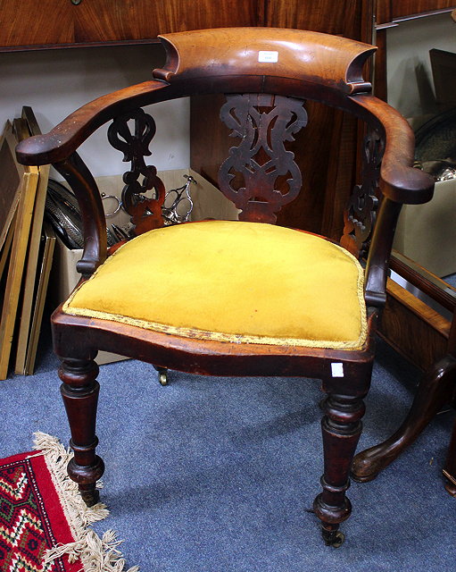 Appraisal: A VICTORIAN CAPTAINS ARMCHAIR the curving back with pierced splats