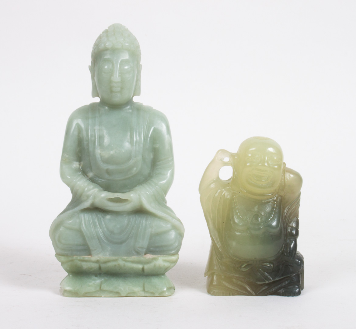 Appraisal: Two Chinese carved jade or hardstone figures Buddha seated on