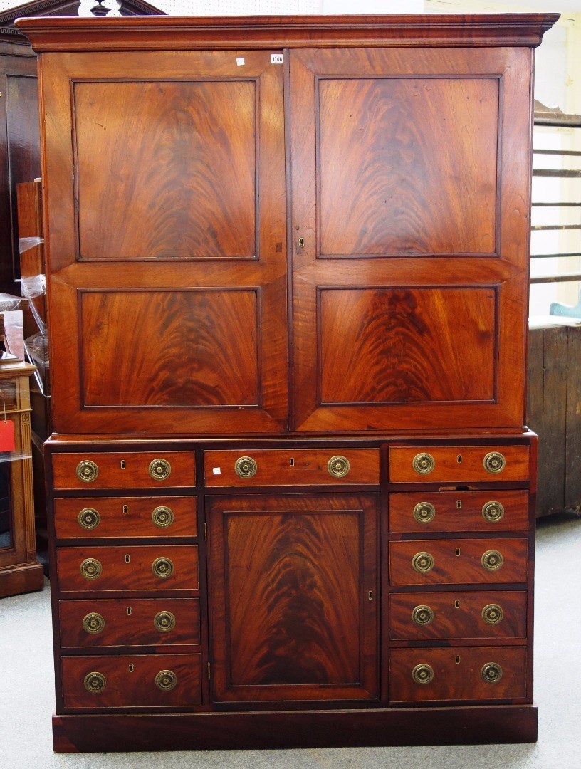 Appraisal: A th century mahogany estate cupboard the pair of panel