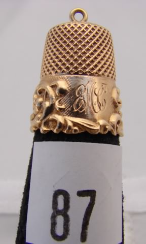 Appraisal: KMD ct gold thimble with hanging loop and decorative band