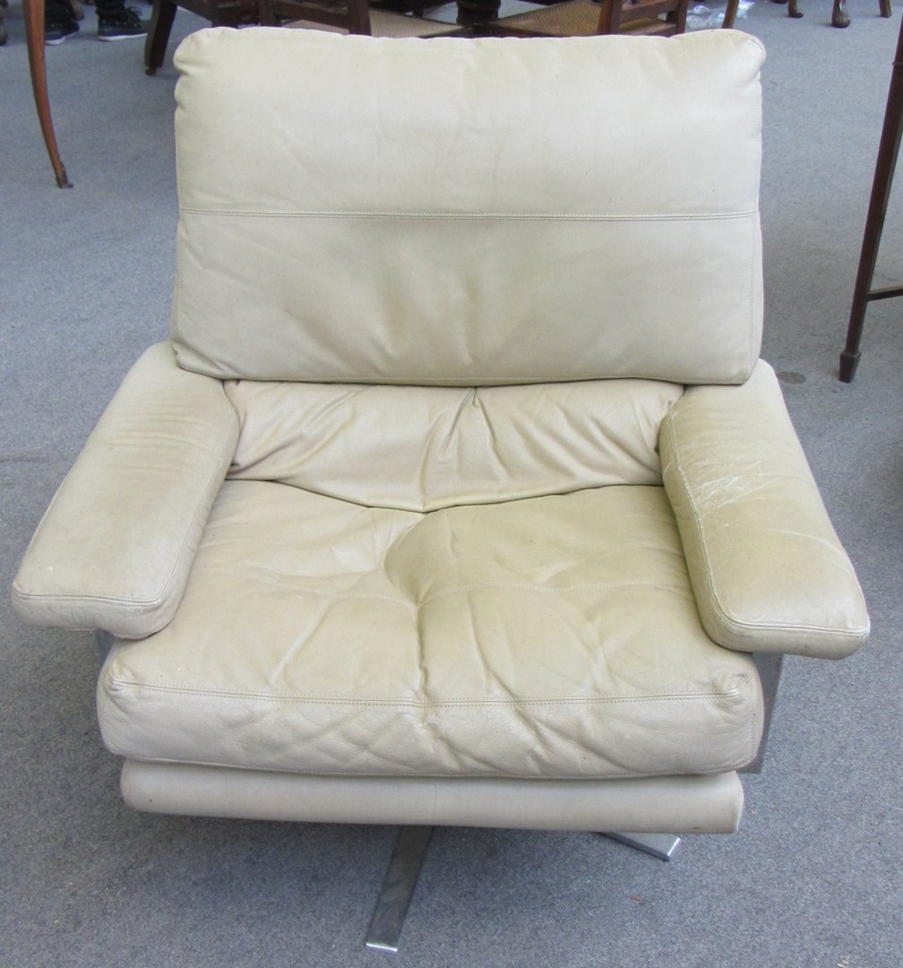 Appraisal: A pair of th century leather upholstered swivel chairs on