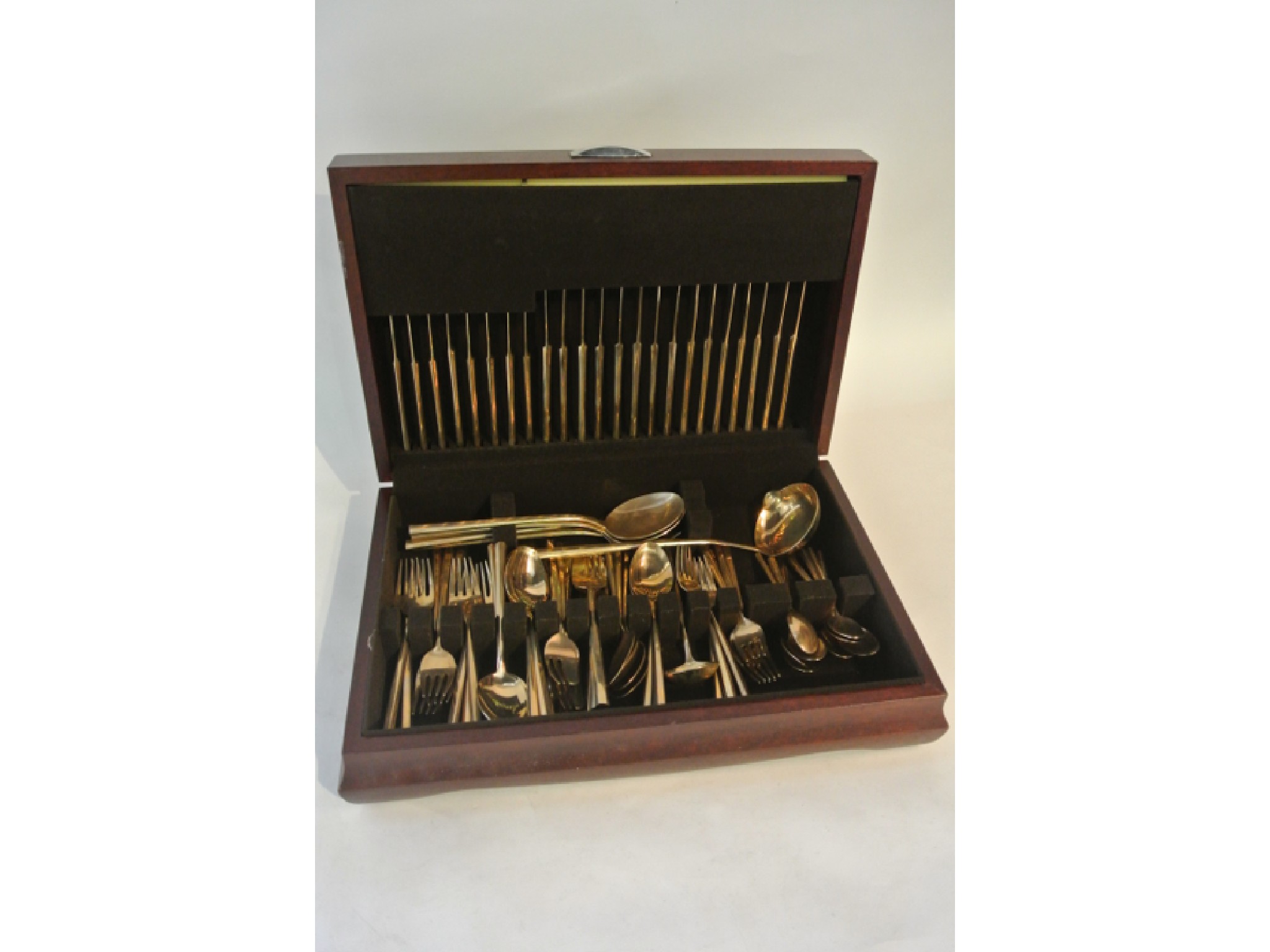 Appraisal: A timber cutlery canteen containing a quantity of gold coloured