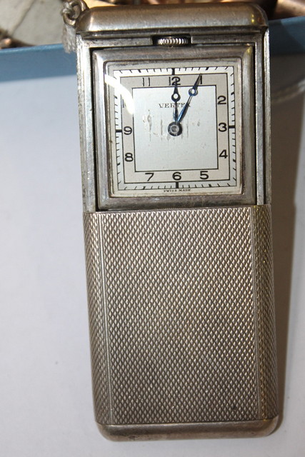 Appraisal: A SILVER TRAVELLING WATCH by Vertex with engine turned sliding