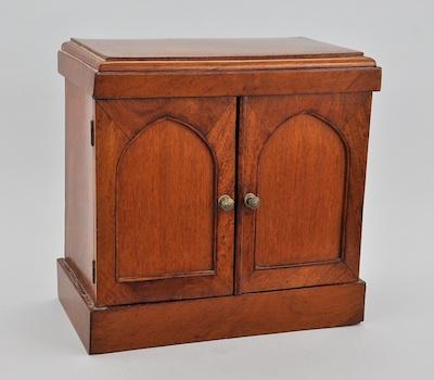 Appraisal: A Mahogany Veneered Desk Top Storage Box Two doors with