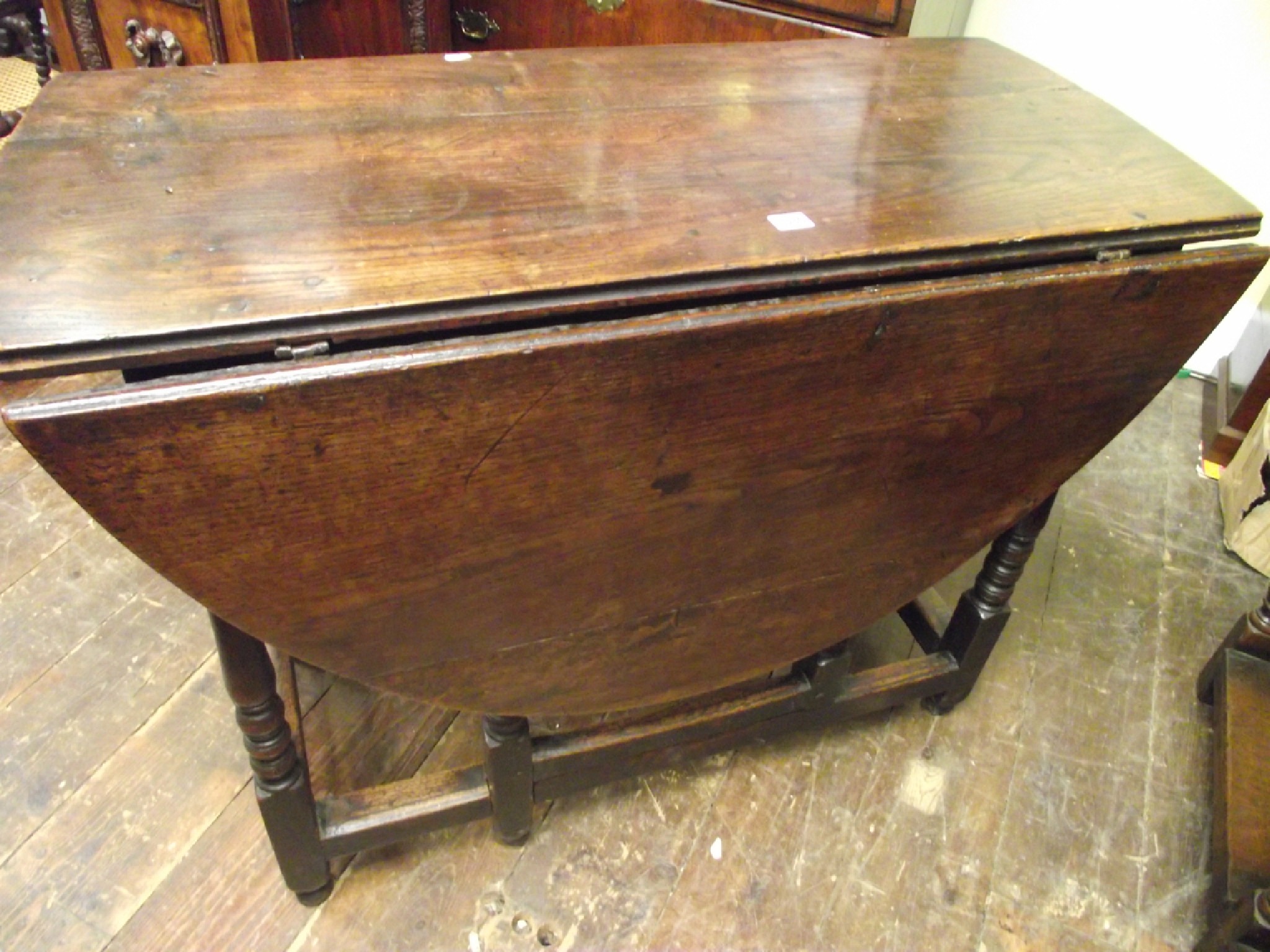 Appraisal: An th century oak gateleg dining table raised on eight