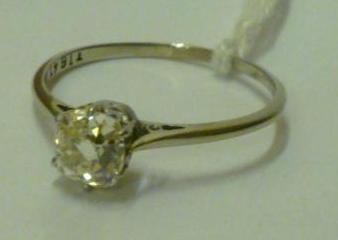 Appraisal: A SOLITAIRE DIAMOND RING the old cushion cut diamond approximately