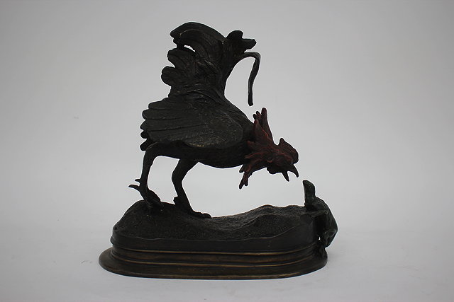 Appraisal: A COLD PAINTED BRONZED FIGURE OF A COCKEREL ATTACKING A