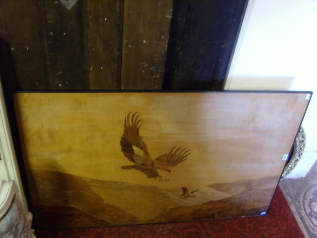 Appraisal: An inlaid panel showing a bird of prey descending upon