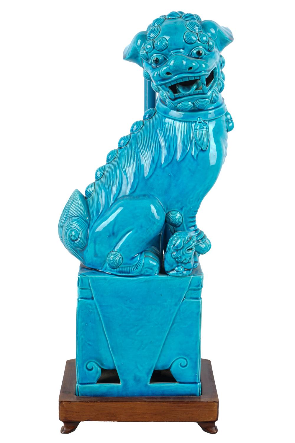 Appraisal: CHINESE CERAMIC FOO LIONblue-glazed mounted on wooden lamp base inches