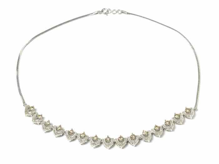 Appraisal: DIAMOND AND FOURTEEN KARAT WHITE GOLD NECKLACE between two equal