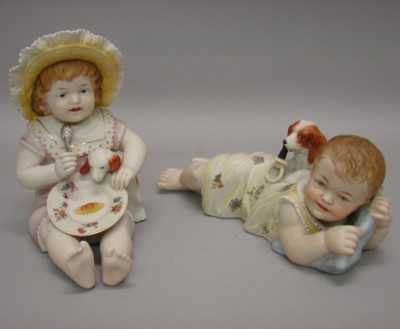 Appraisal: -Piano Figurines children with dogs L Child on stomach holding