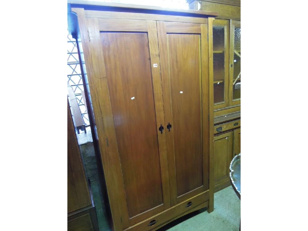 Appraisal: A modern cherry wood wardrobe enclosed by a pair of