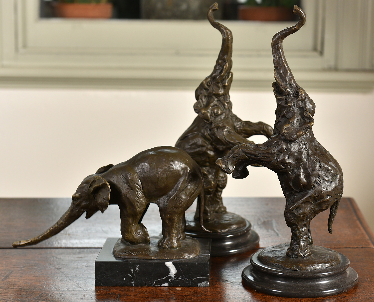 Appraisal: TWO MATCHING BRONZE ELEPHANTS IN STANDING POSES MOUNTED ON MARBLE