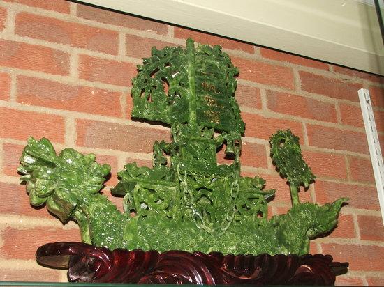 Appraisal: A CHINESE SIMULATED JADE DRAGON BOAT with stained wooden stand