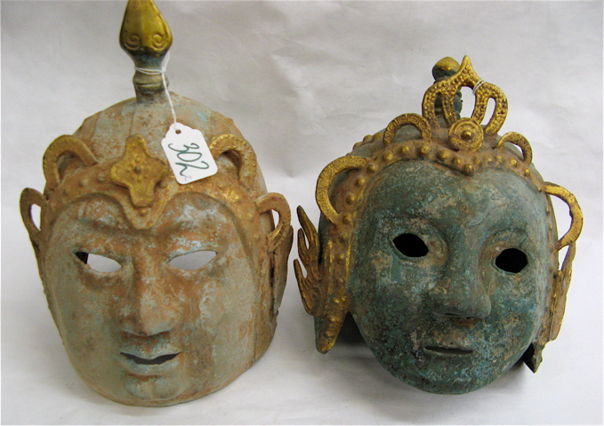 Appraisal: TWO CHINESE PATINATED METAL HELMET MASKS with pierced openings and