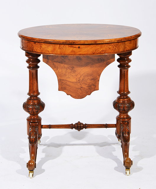 Appraisal: A VICTORIAN OVAL WALNUT WORK TABLE with decorative boxwood inlay