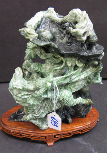 Appraisal: A CHINESE JADE FIGURAL CARVING AND STAND The group of