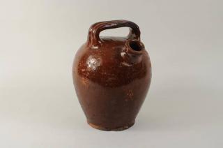 Appraisal: Redware Harvest Jug Redware harvest jug with ribbed handle high