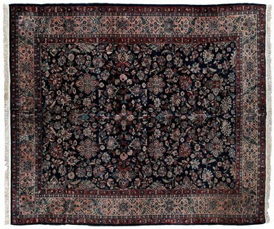 Appraisal: Sarouk rug typical floral designs on dark blue ground ft