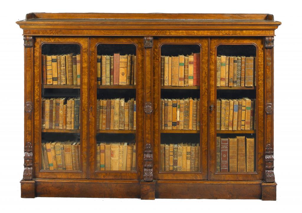 Appraisal: A VICTORIAN WALNUT BOOKCASE the rectangular tooled green leather inlet