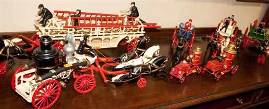 Appraisal: Seven painted cast iron reproduction fire engines Estimate - All