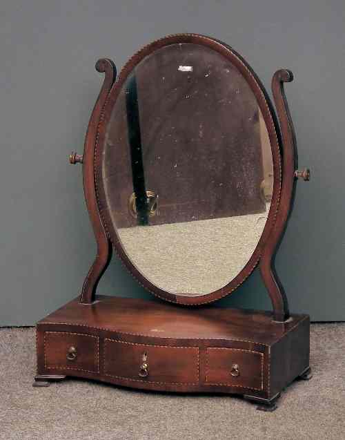 Appraisal: An Edwardian mahogany framed oval toilet mirror of Sheraton design