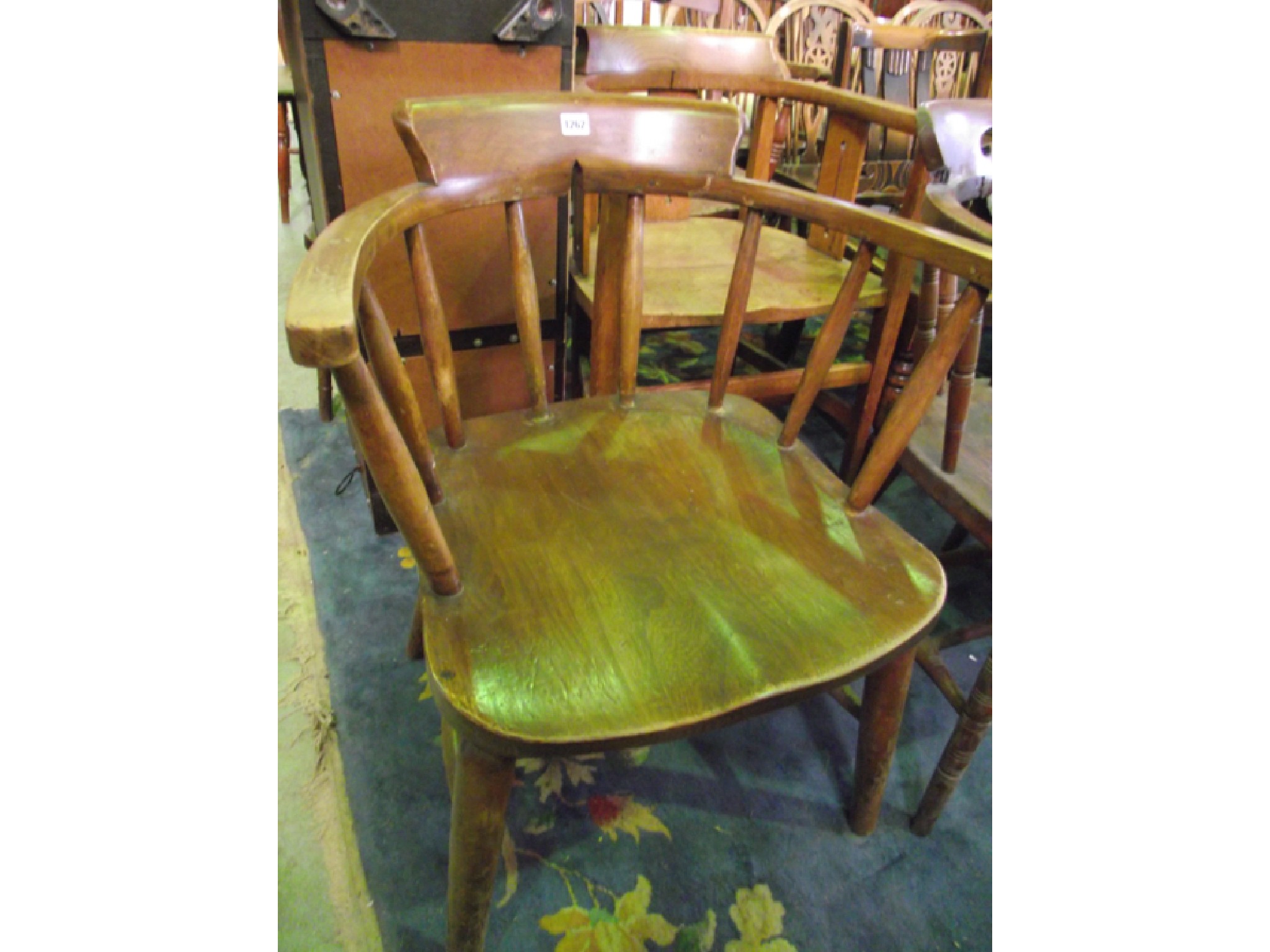 Appraisal: A pair of Edwardian smokers bow elbow chairs in the