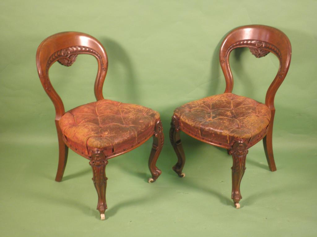 Appraisal: A pair of Victorian walnut balloon back dining chairs by