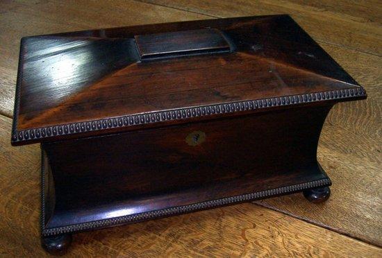 Appraisal: A late Regency rosewood sarcophagus shaped tea caddy with knulled