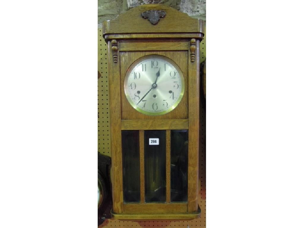 Appraisal: A 's oak and glass panelled wall clock with three