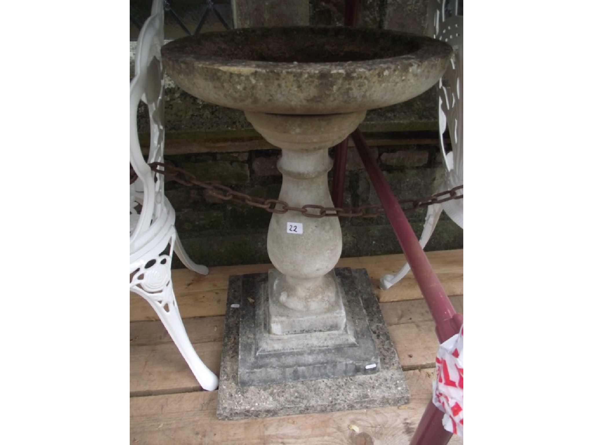 Appraisal: A weathered cast composition stone three sectional bird bath with